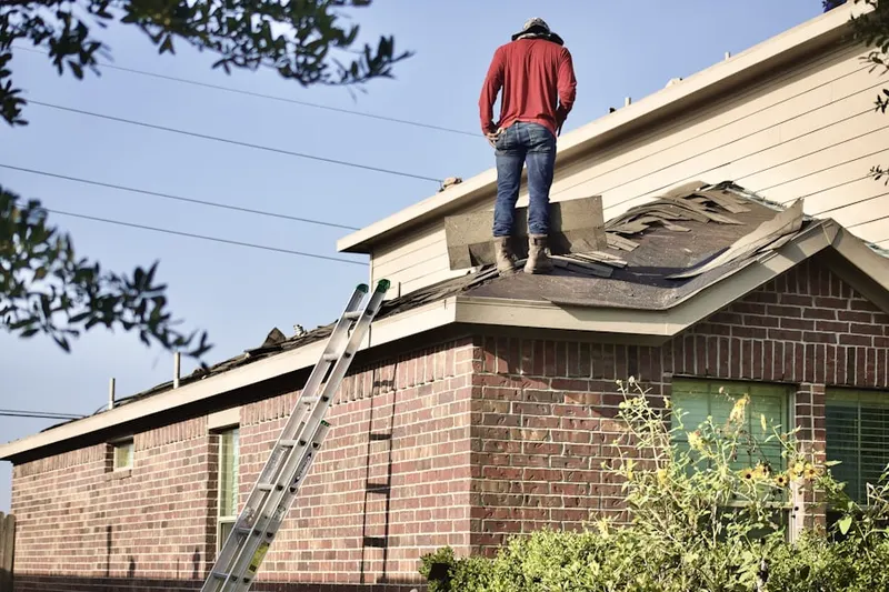 Professional roofer working on a residential roof in Academy Lane
